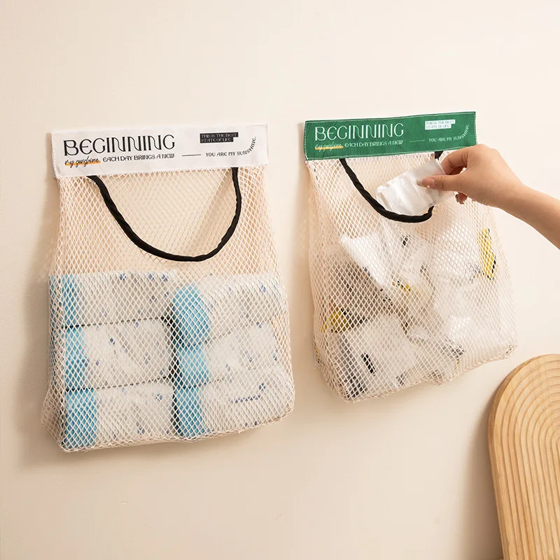 A Person is Keeping Plastic Bags in a Sticky Wall Mounted Storage Organizer Bag.