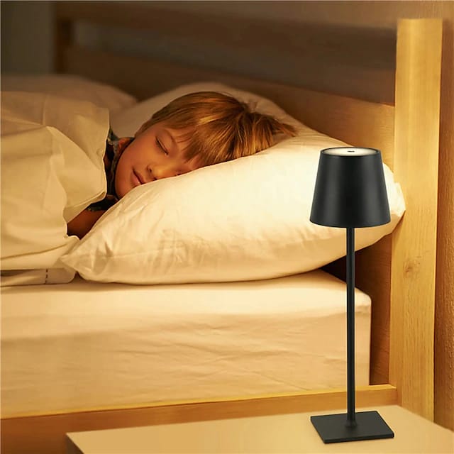 A Child is Sleeping By Placing USB Cordless LED Table Lamp Near His Bed.
