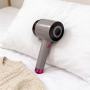 USB Rechargeable Fabric Lint Remover Placed in a Bed.