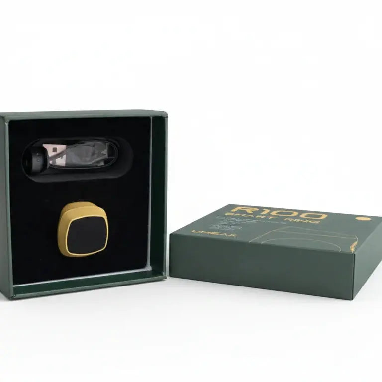 Gold smart ring in a black box with a green box.
