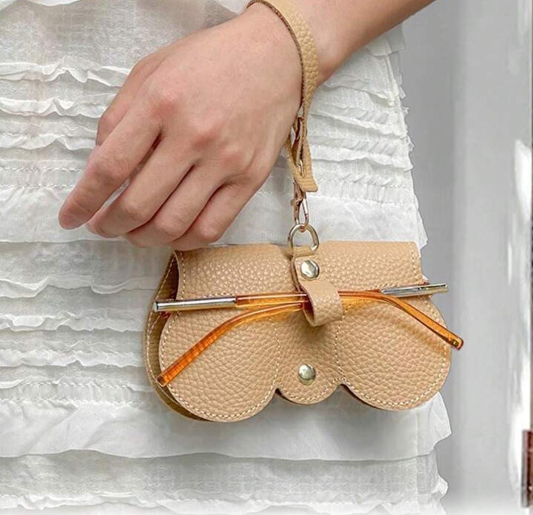 A Person is Holding Unisex Portable Glasses Bag in Beige Color.