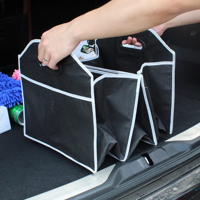 A Man Folds  Foldable Multi-Purpose Vehicle Storage Bag.