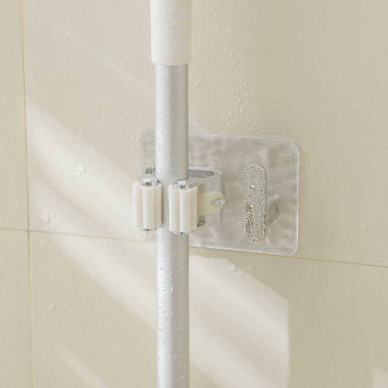 A Wall-Mounted Mop & Broom Holder is Holding Mop Fixed on a Bathroom Wall.
