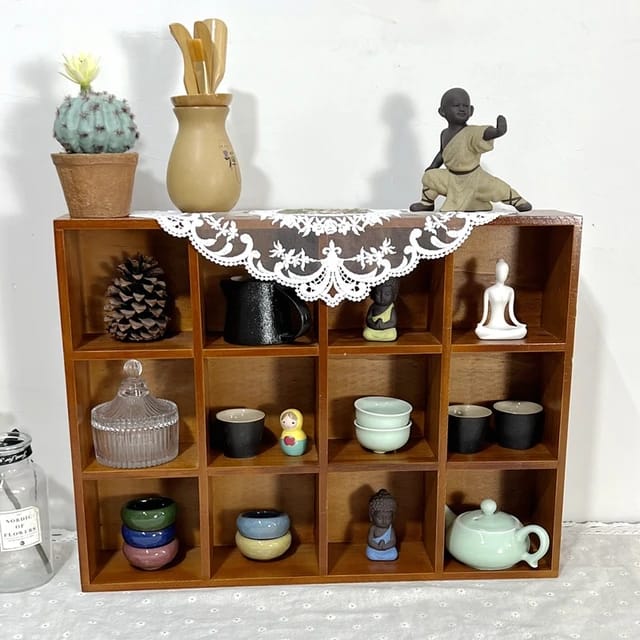 Wooden Wall Hanging Display Rack With Decors and Pots Are Diaplayed On it.