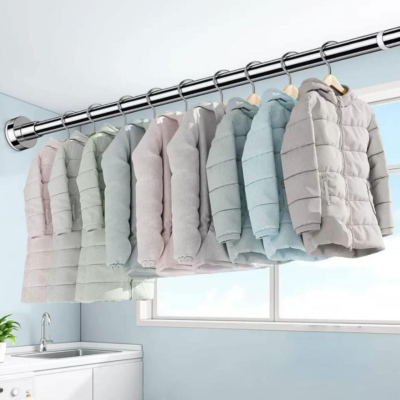 Clothes Are Hanged On the Wall Mounted Retractable Cloth Hanger Stand.