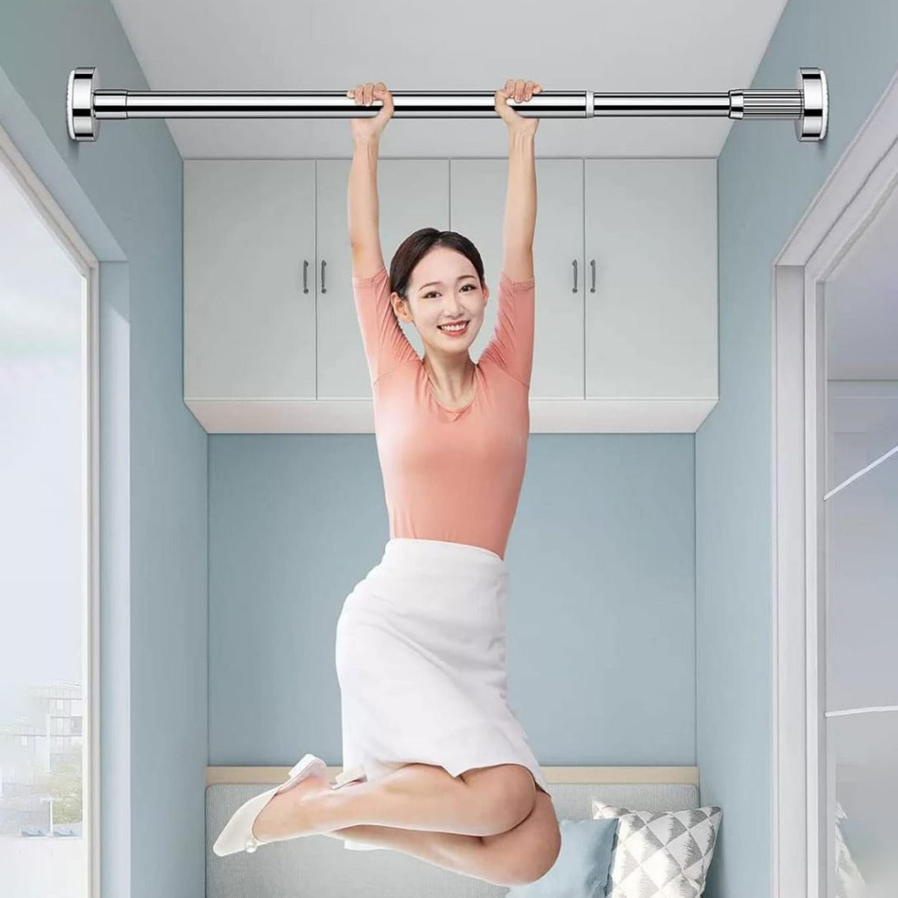 A Woman is Hanging On the Wall-Mounted Retractable Cloth Hanger Stand.