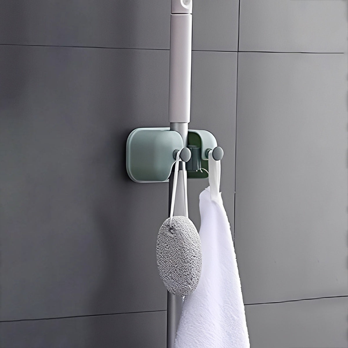 Mop and Other Cleaning Accessories are Organized at Wall Mounted Single Mop Holder.