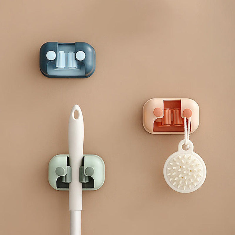 Wall Mounted Single Mop Holders Holding Mops Attached on Wall.