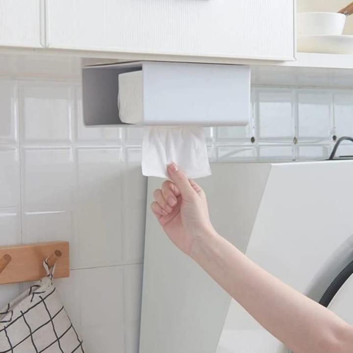 A Person is Taking Tissue Kept in a Wall Mounted Tissue Box Holder Dispenser Rack.