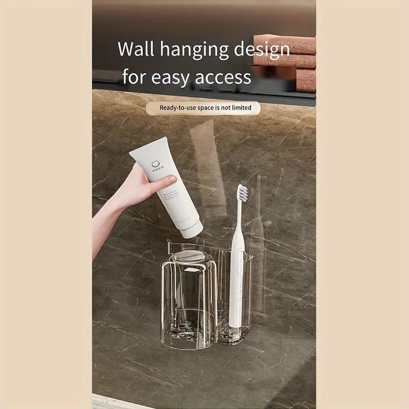 A Person is Taking Toothpaste From Wall Mounted Toothbrush Holder Stand.