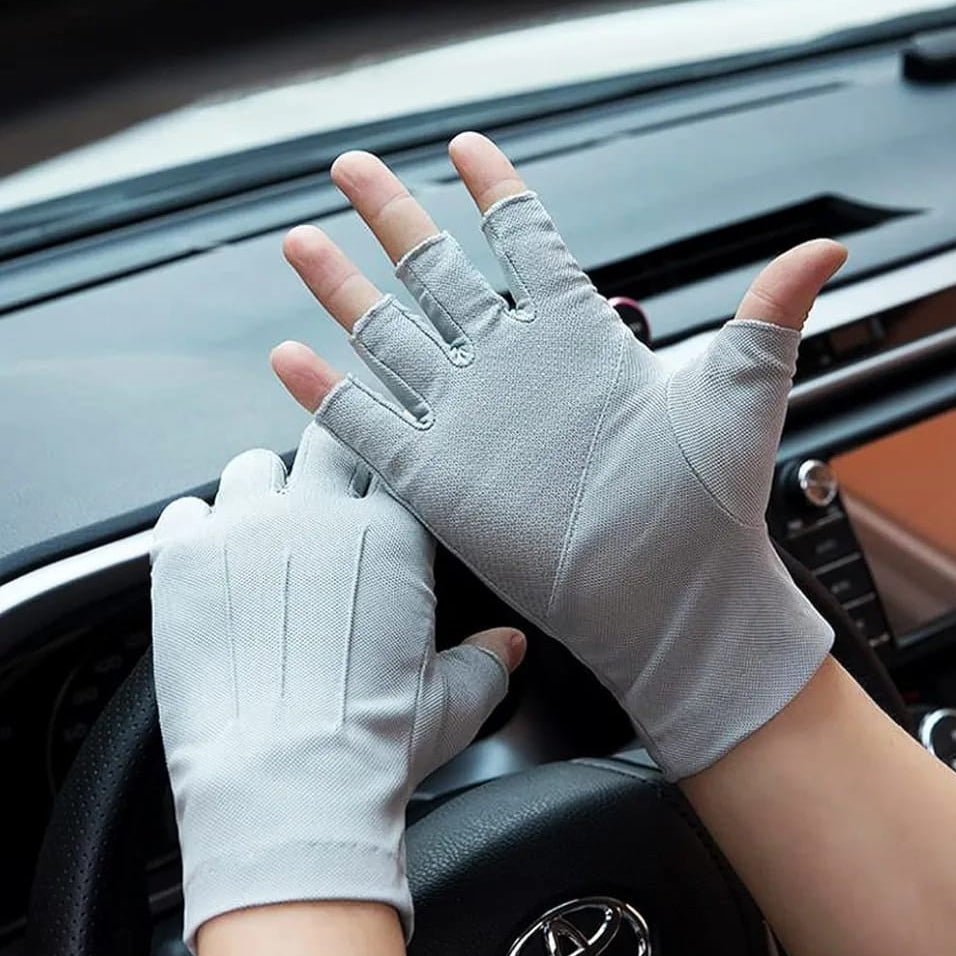 A Person is Wearing Fingerless Gloves While Driving.