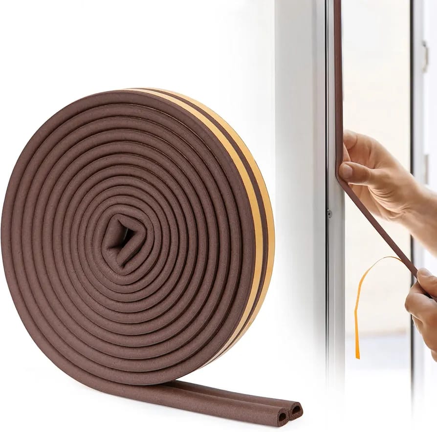 A Person is Sticking Weather Stripping Door Tape.