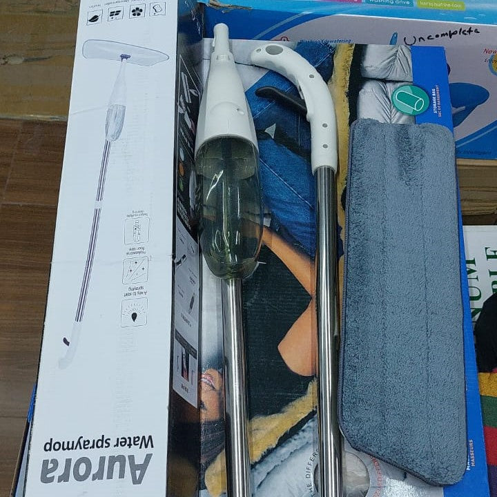Disassembled Lightweight Water Spray Mop and its box placed on a floor 
