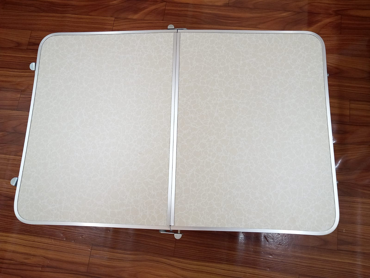The portable folding mini table is placed on the floor
