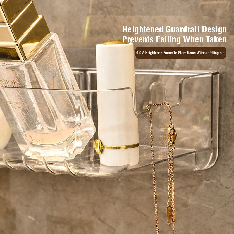 A transparent plastic shelf designed for bathroom storage, featuring a gold necklace and perfume bottle, perfect for organizing toiletries and cosmetics