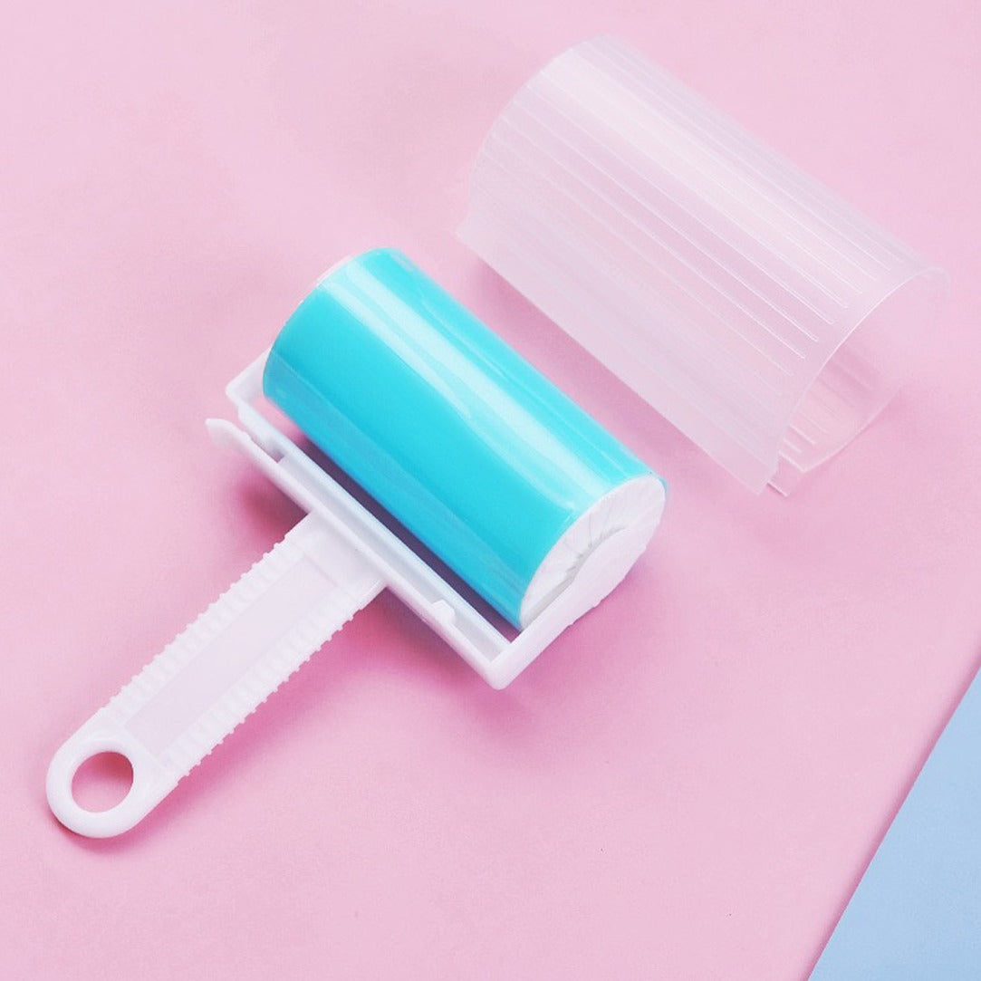 Reusable Lint Remover in Blue color opened with cap kept on a pink surface 