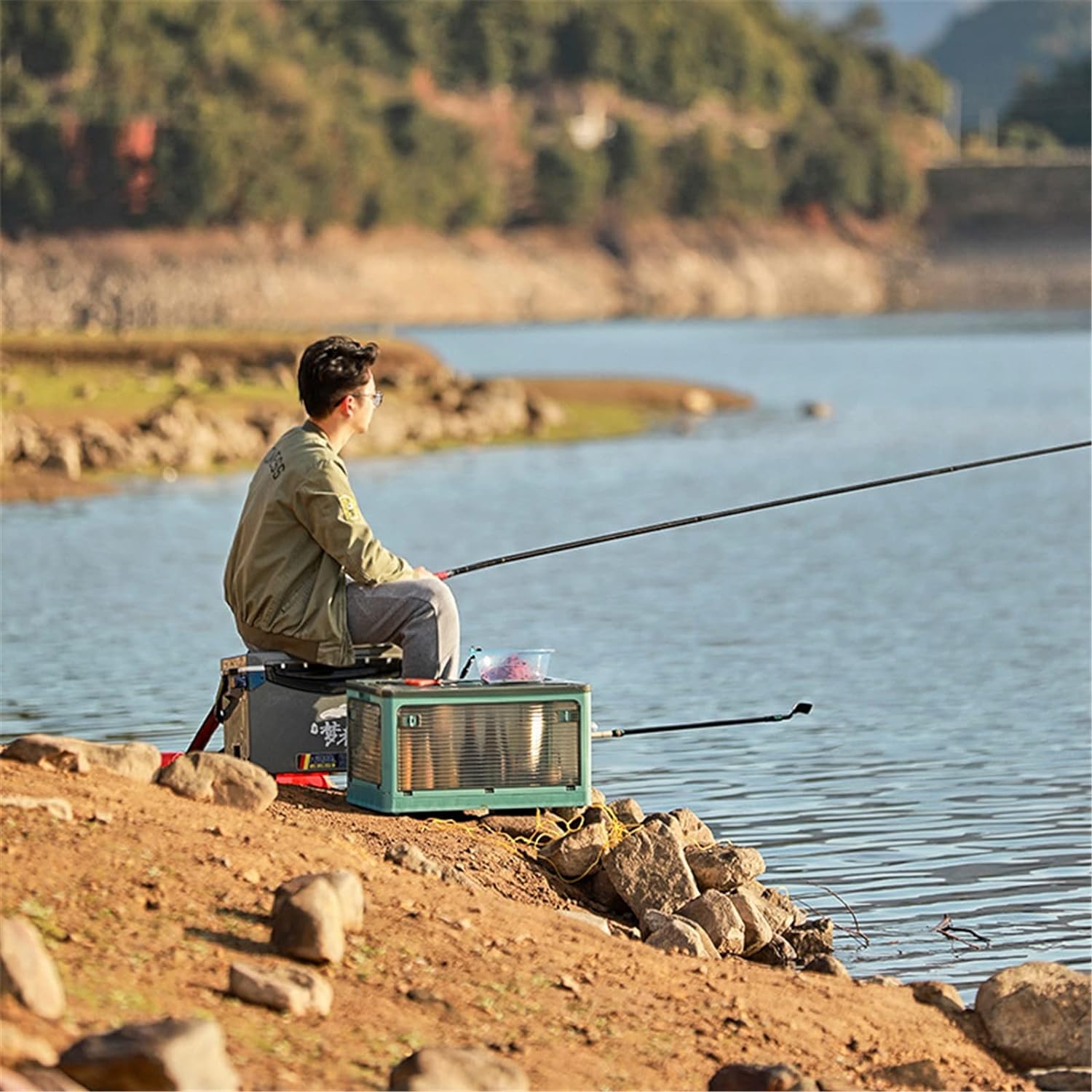 A person uses Foldable Transparent Storage Box with Wheels while fishing 