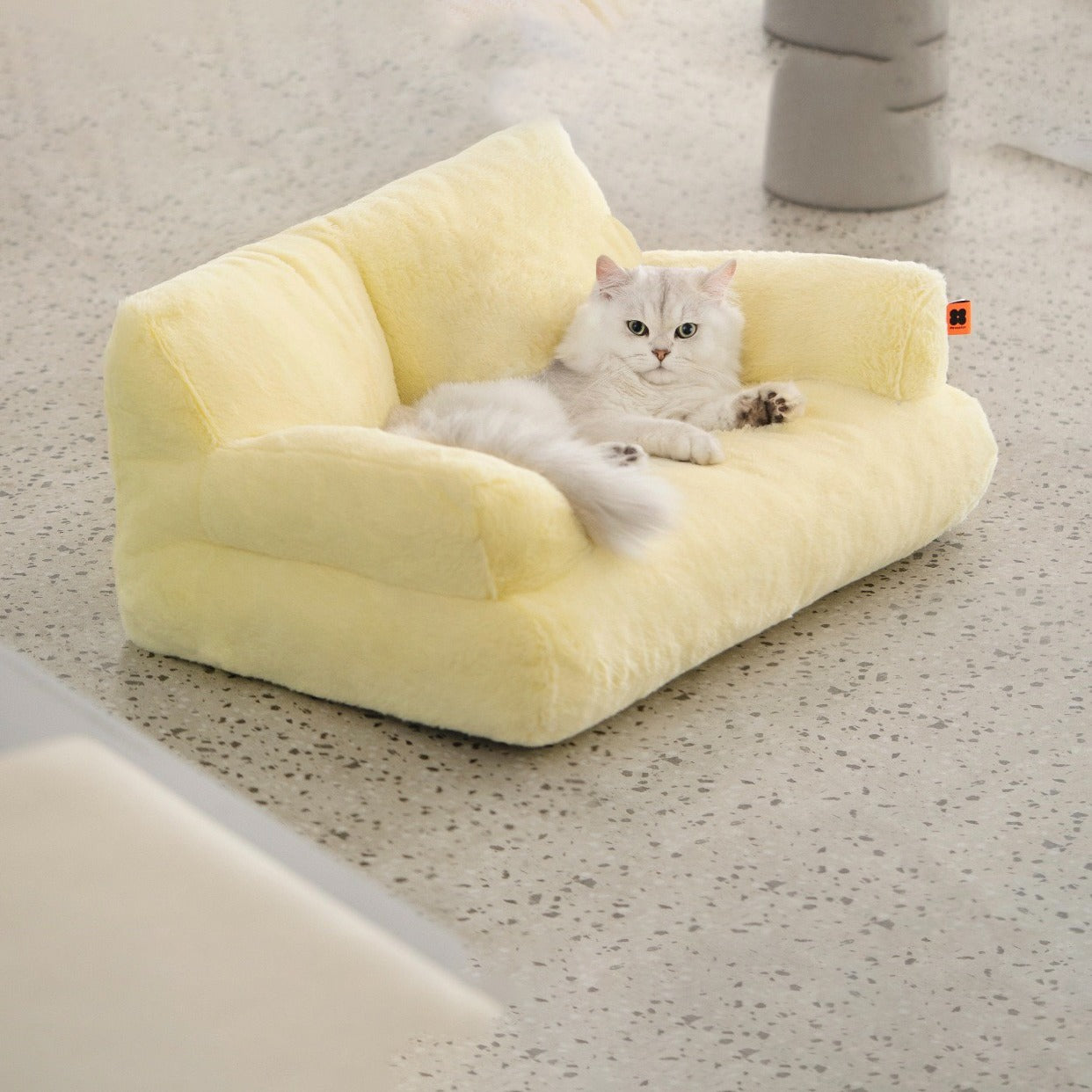 A cat lying on a yellow color Cat Sofa Couch Cushion 