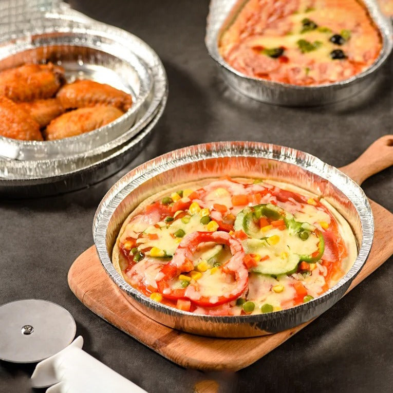 Pizza served in an Aluminum Foil Plate kept on top of cutting board 