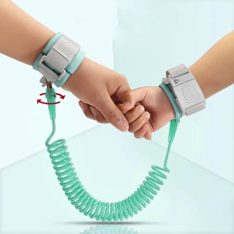 Hands tied with Green Child Safety Harness Leash holding each other and the picture displays the lock system on the product 