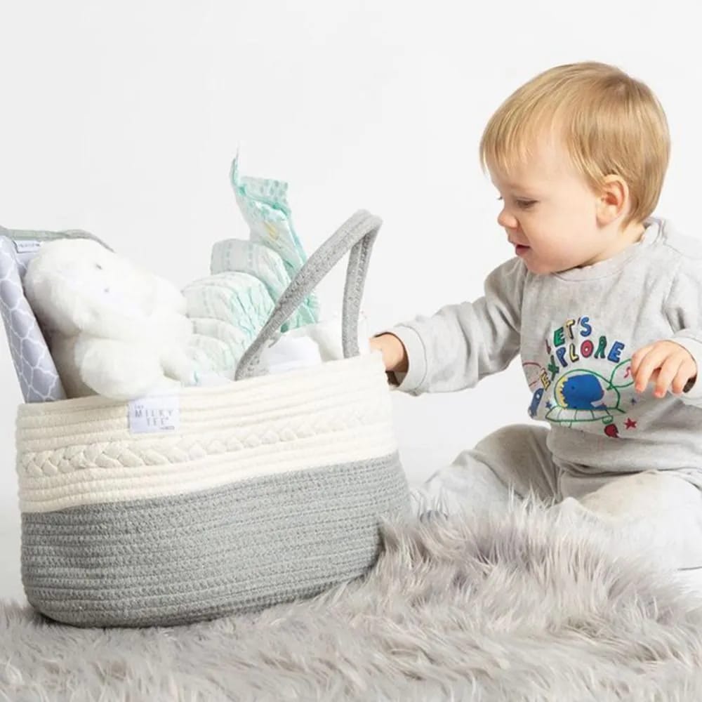 A baby holding a well organized Nursery Storage Basket 