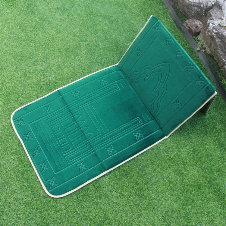 Green color Islamic Foldable Prayer Mat placed on a grass with backrest opened