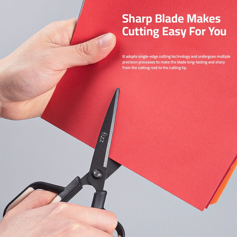 A person is cutting a chart paper using a Scissor with Paper Cutting Blade