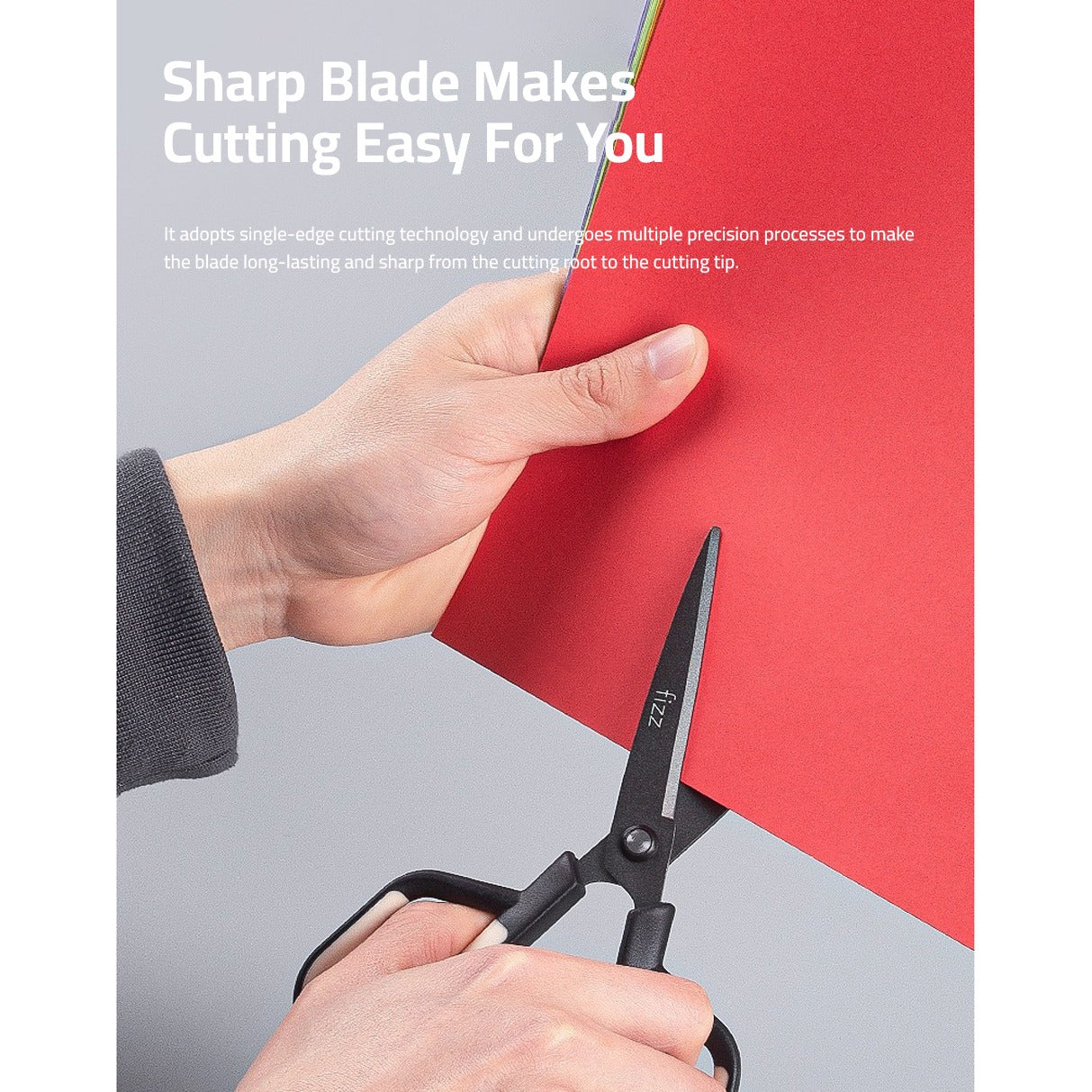 A person is cutting a chart paper using a Scissor with Paper Cutting Blade