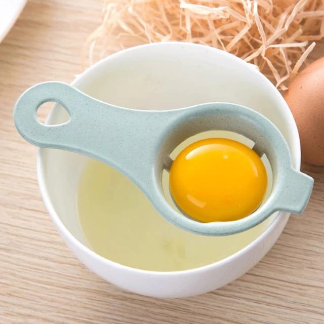 Egg Separator Tool carrying egg yolk placed on top of a bowl while at the process of separating egg yolk