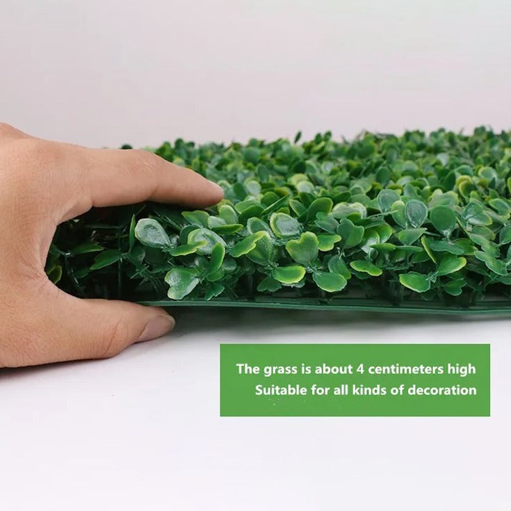 A person holding and exposing the thickness of Artificial Grass Plant  