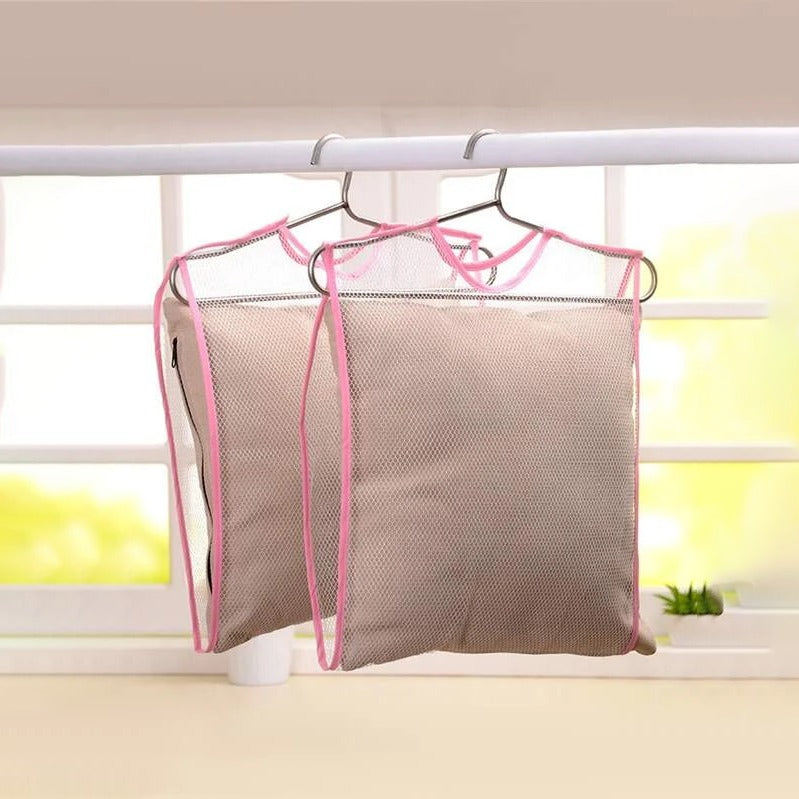 2 Toy and Pillow Drying Net with pillow in it hung on a white color rod next to a window 