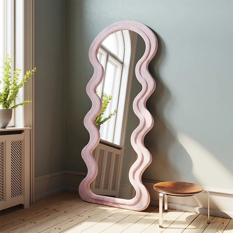 Curve shaped Full-Length Mirror laying on a wall 