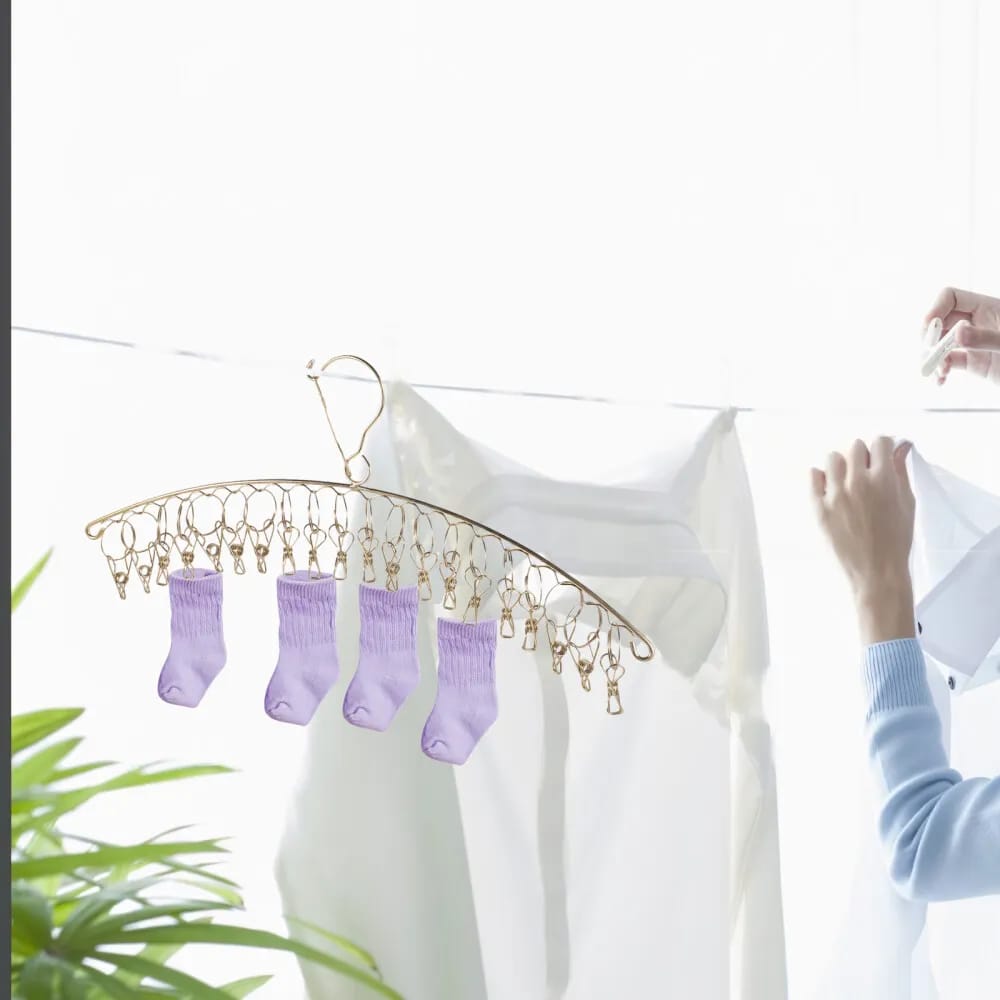 Woman hanging clothes in Stainless Steel Clothes Drying Hanger