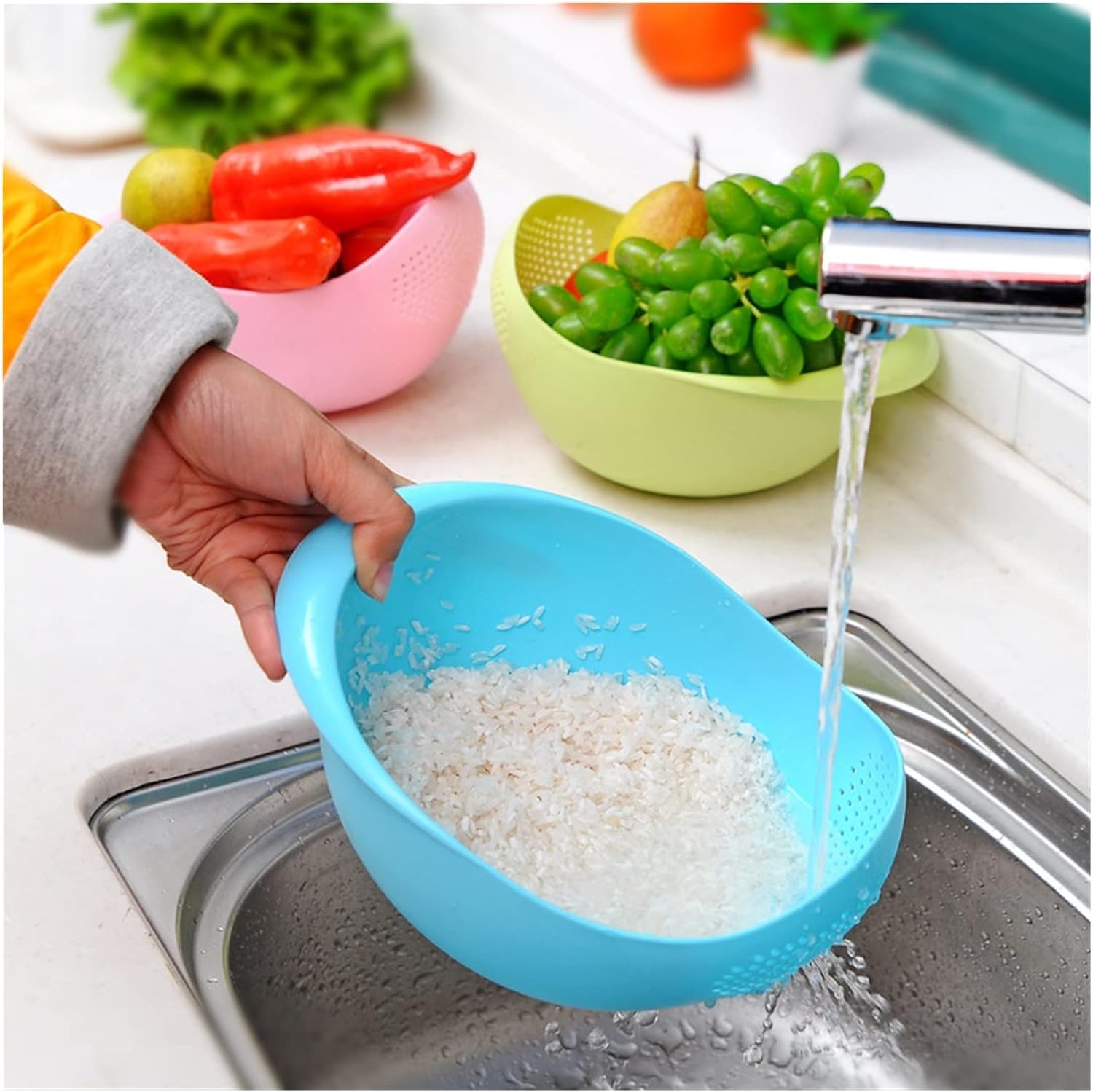 Rice being washed with the help of Plastic Rice Washing Strainer Basket and image also displays another two pieces of Plastic Rice Washing Strainer Baskets with fruits and vegetables kept in it