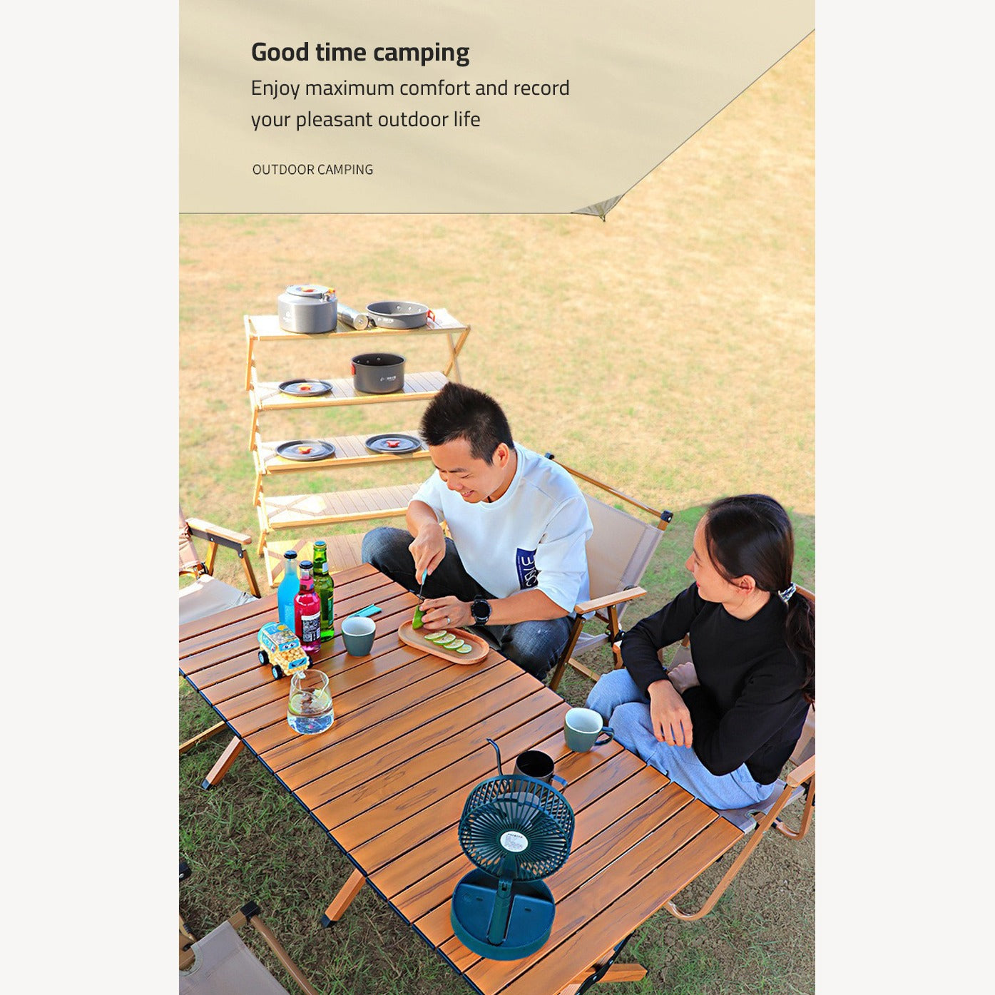 A person cutting lemons using cutting board placed on top of Outdoor Portable Camping Table in a camping 