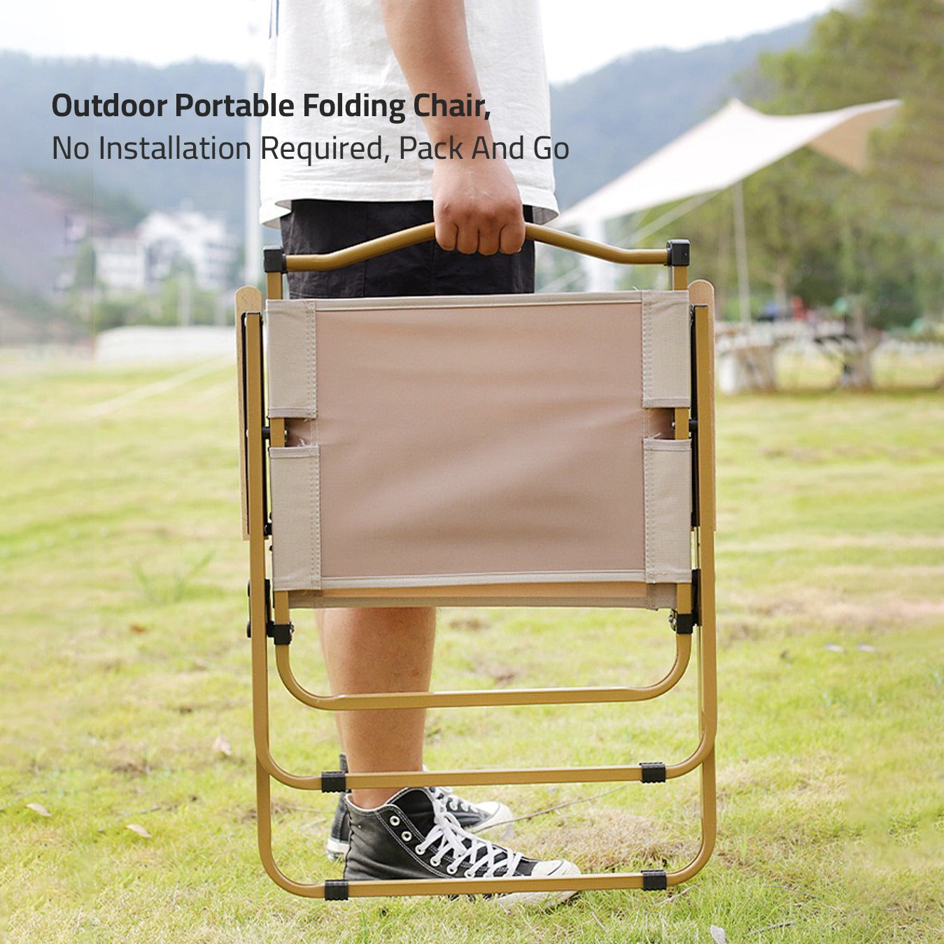 A person holding Outdoor Camping Folding Chair in a park to use for picnic
