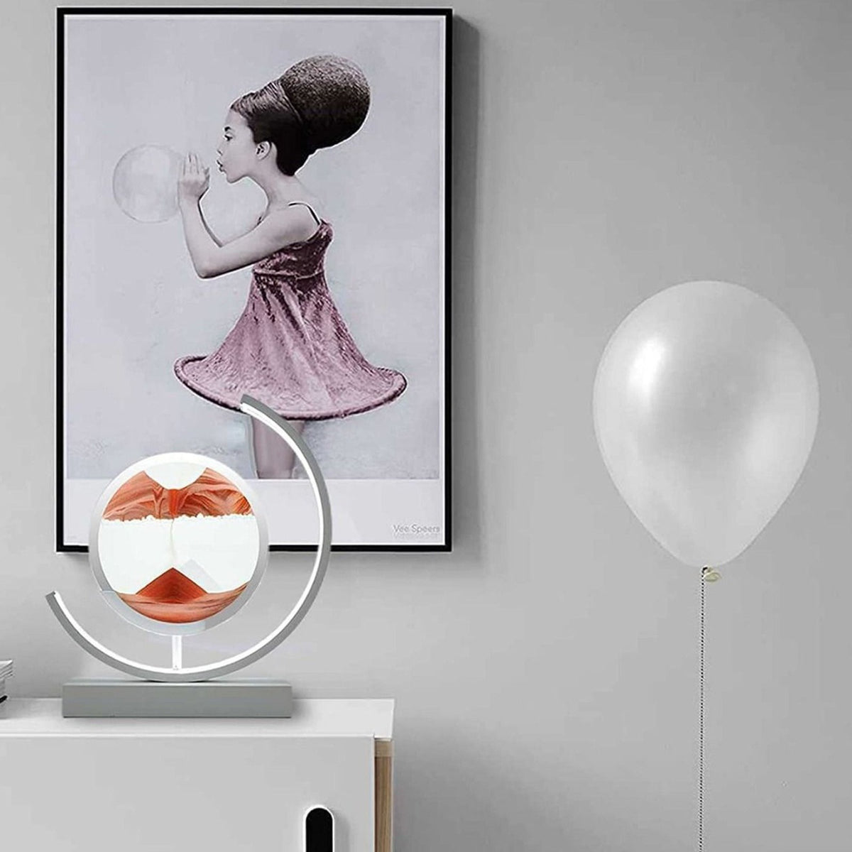 Quicksand 3D Table Lamp placed on a table near to a portrait and a balloon 