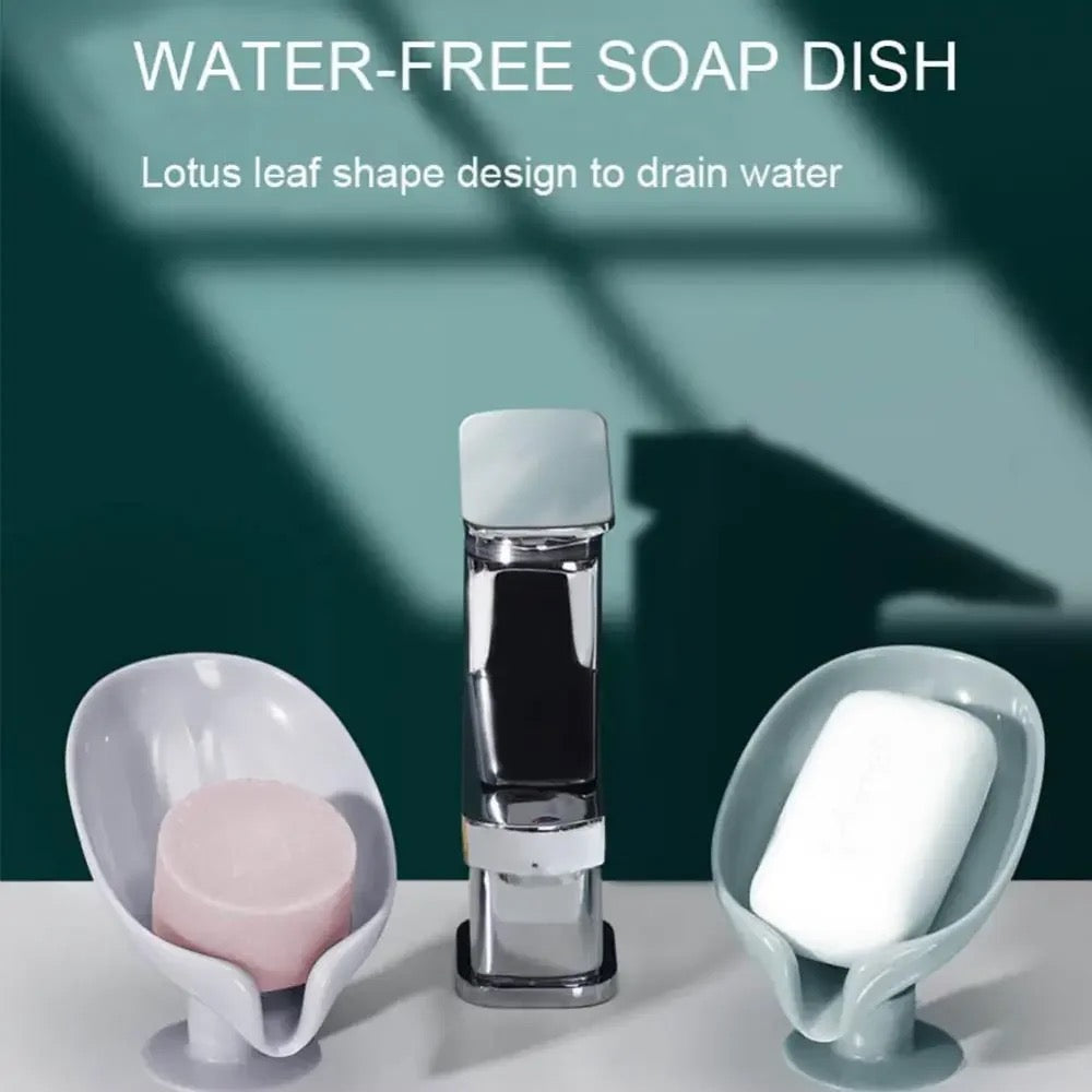 Two Leaf Shaped Soap Holders with soap kept on top of it been placed in left and right side of a wash basin faucet