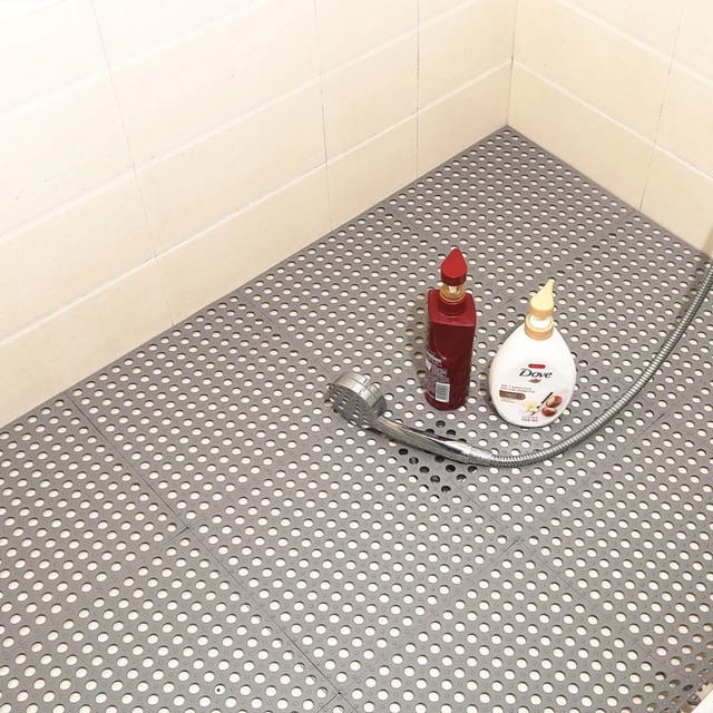 Grey color Interlocking Non-Slip Bathroom Mat floored in a bathroom