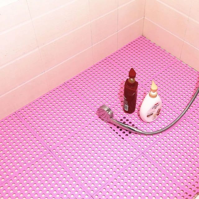 Pink color Interlocking Non-Slip Bathroom Mat floored in a bathroom