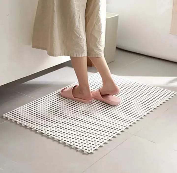 A person standing on top of Interlocking Non-Slip Bathroom Mat
