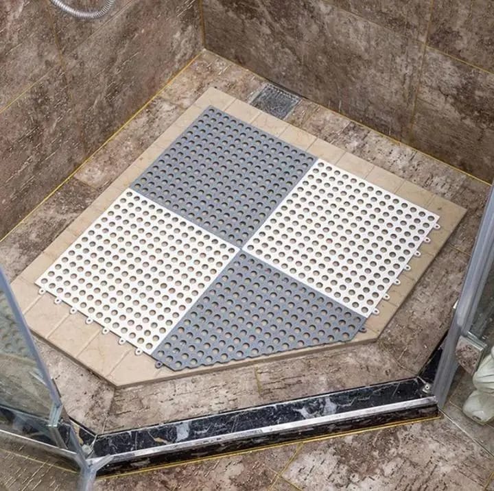 Interlocking Non-Slip Bathroom Mat floored in a glass shower 
