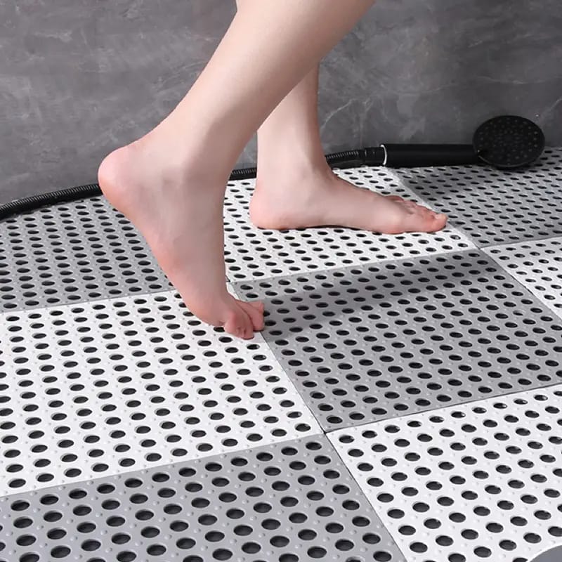 A person standing on top of Interlocking Non-Slip Bathroom Mat
