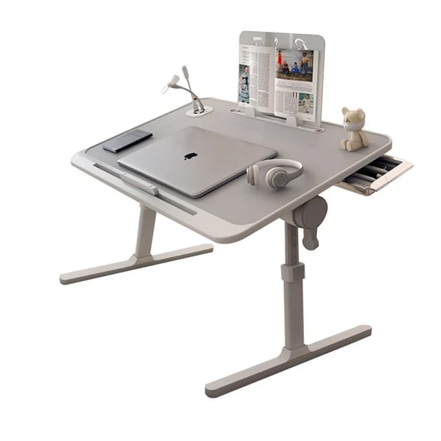 Laptop, headset, and book neatly arranged on the Adjustable Bed Laptop Table 