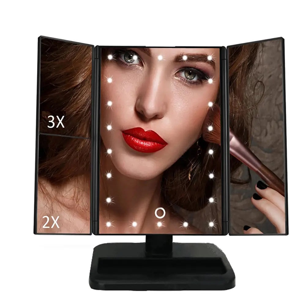 A woman gazes into a tri-fold makeup mirror with LED lights