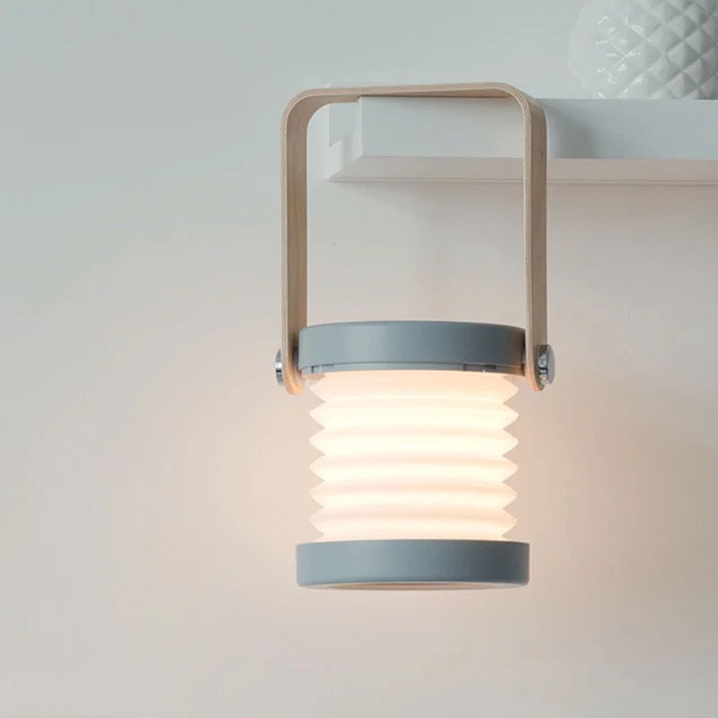 A shelf displays a Retractable Table Lamp with USB Rechargeable with a wooden handle