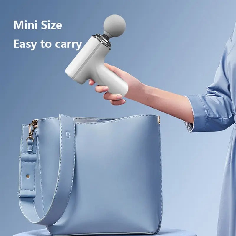 A woman holding the Portable Mini Massage Gun, easily fitting into your bag for outdoor travels