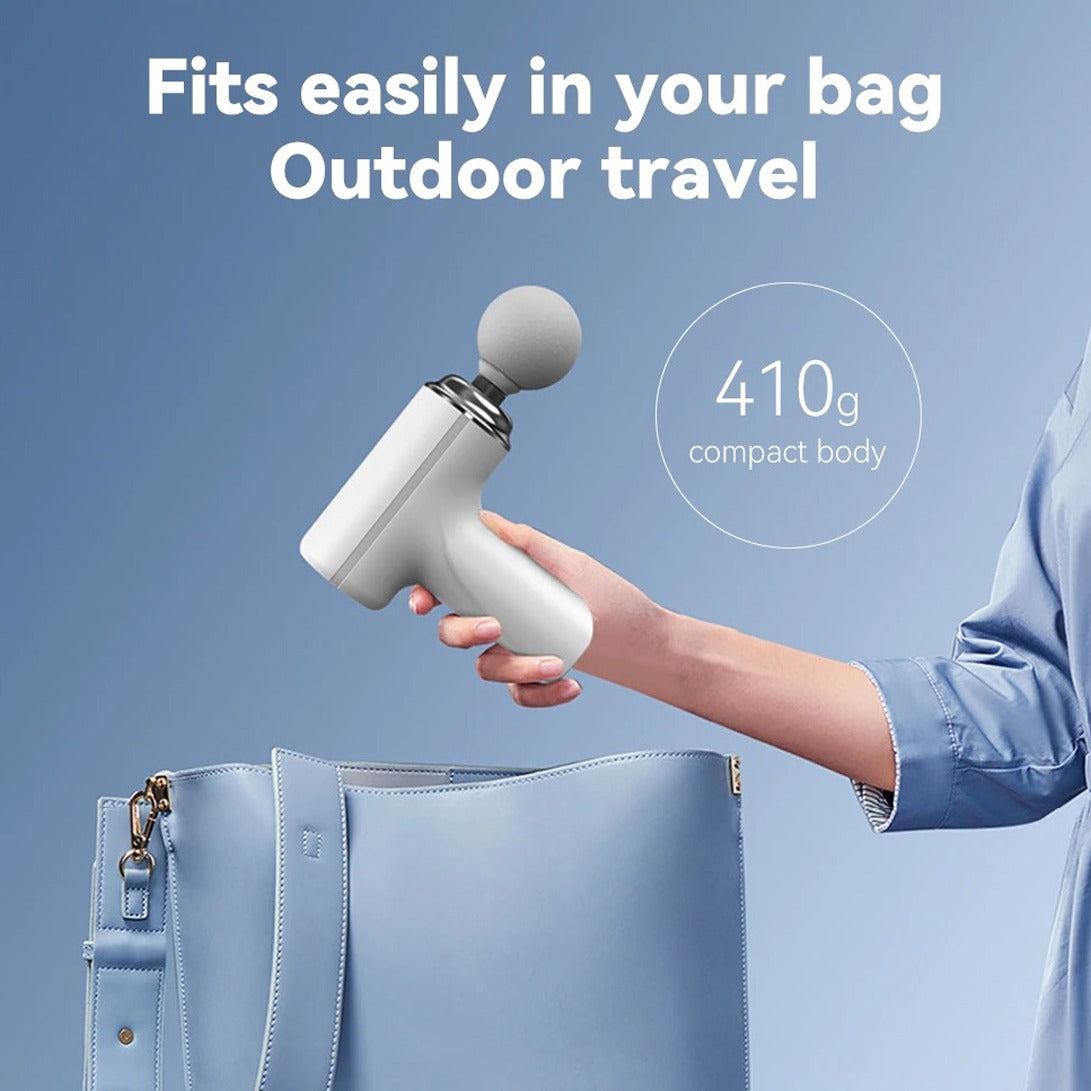 A woman holding the Portable Mini Massage Gun, easily fitting into your bag for outdoor travels