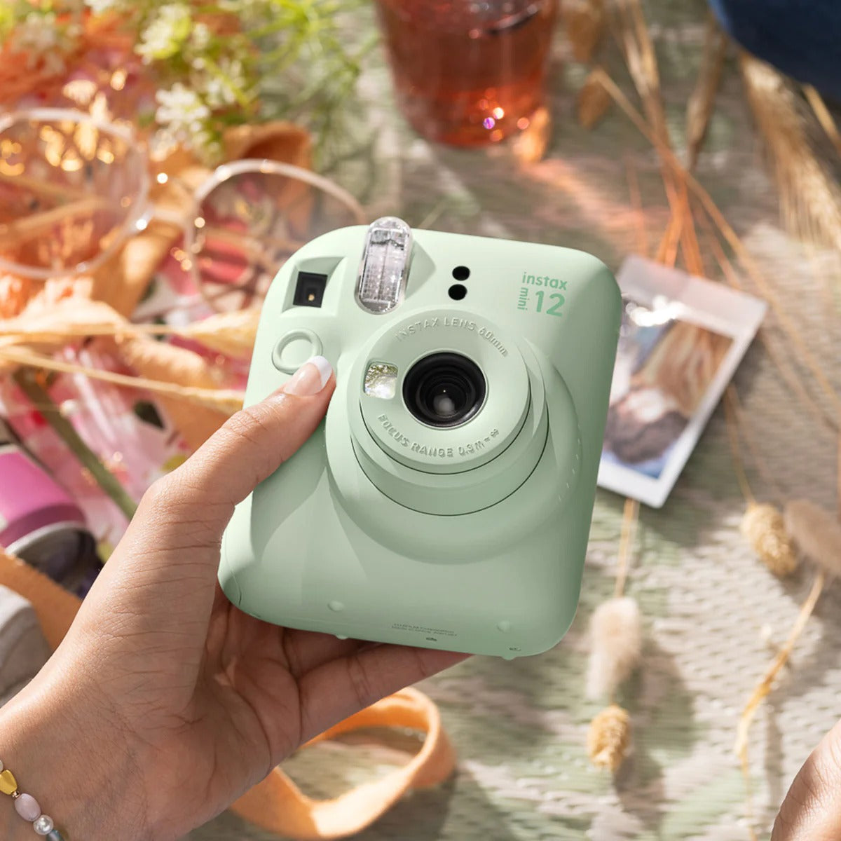 lady holding Fujifilm Instax Mini 12 Camera