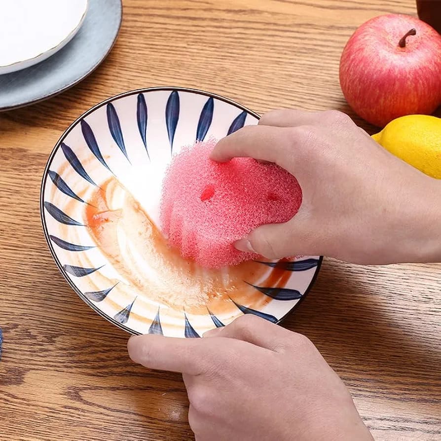 A Dish is Cleaning Using Smiley Face Kitchen Scrubber.